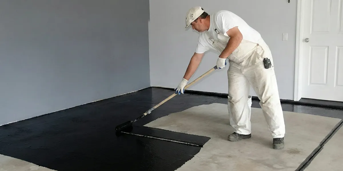 basement waterproofing professional applying waterproof coating to protect a basement floor in Fort Lauderdale, FL