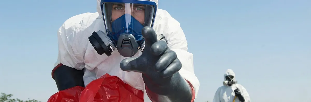 sewage clean up technician wearing protective gear handling biohazard materials in Fort Lauderdale, FL